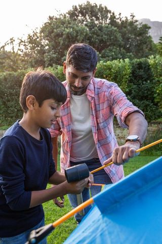 Father and Son Collaborating on Backyard Camping Tent Setup