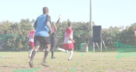Referee signaling during amateur soccer match with player tracking data overlay on pitch