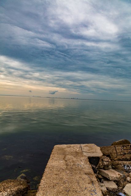 Peaceful Rocky Coastal View with Dramatic Cloudy Sky - Download Free Stock Images Pikwizard.com