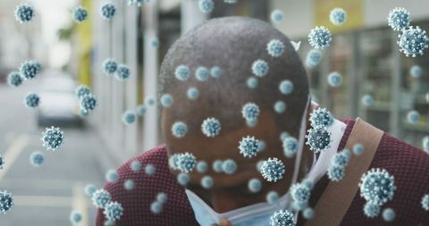 Masked man breathes as covid-19 cells float in urban scene