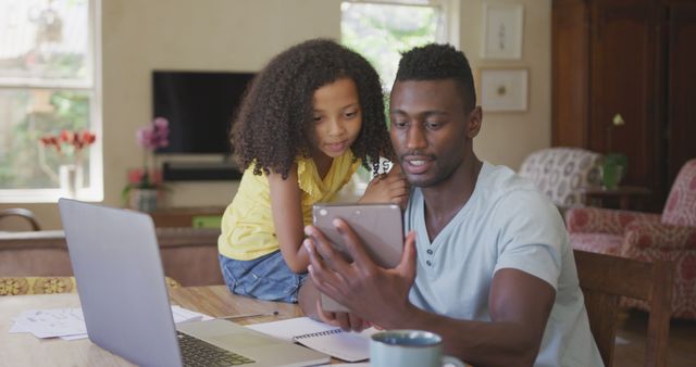 Father Working on Tablet with Curious Daughter at Home - Download Free Stock Images Pikwizard.com