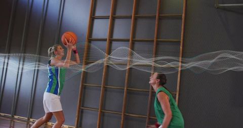 Female Athletes Engaged in Intense Basketball Game in Gym