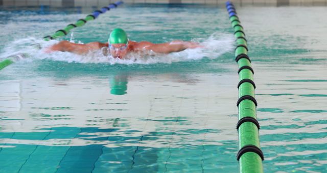 Male Swimmer Competing in Butterfly Stroke in Indoor Swimming Pool - Download Free Stock Images Pikwizard.com