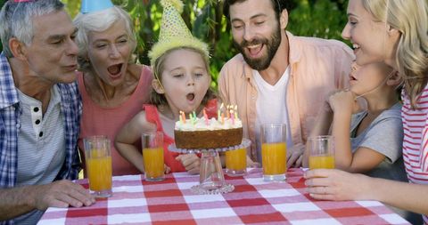 Family Celebrating Birthday Outdoors, Child Blowing Out Candles - Download Free Stock Images Pikwizard.com