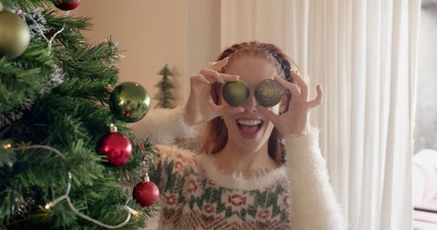 Woman Enjoying Christmas Preparations in Cozy Living Room