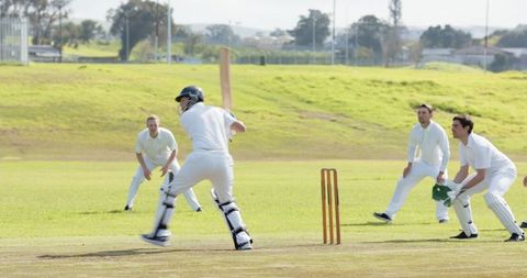Cricket Match on a Suburban Pitch with Players in Action