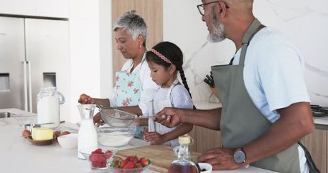 Family cooking together in modern kitchen enhancing learning
