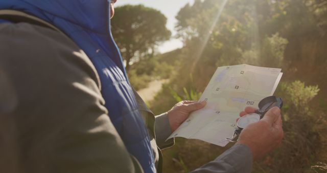 Man Holding Map and Compass on Outdoor Trek - Download Free Stock Images Pikwizard.com