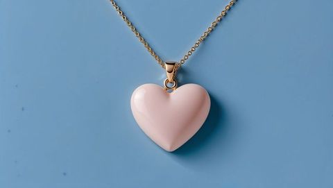 Elegant gold necklace with pink heart-shaped pendant