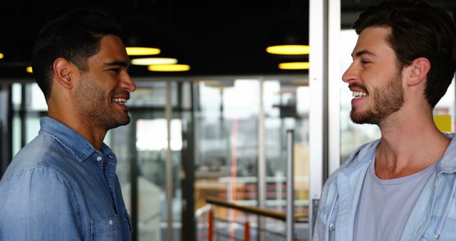 Two Smiling Men Having Conversation in Modern Office - Download Free Stock Images Pikwizard.com