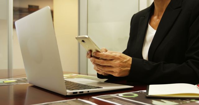 Professionals Using Smartphone and Laptop in Office - Download Free Stock Images Pikwizard.com