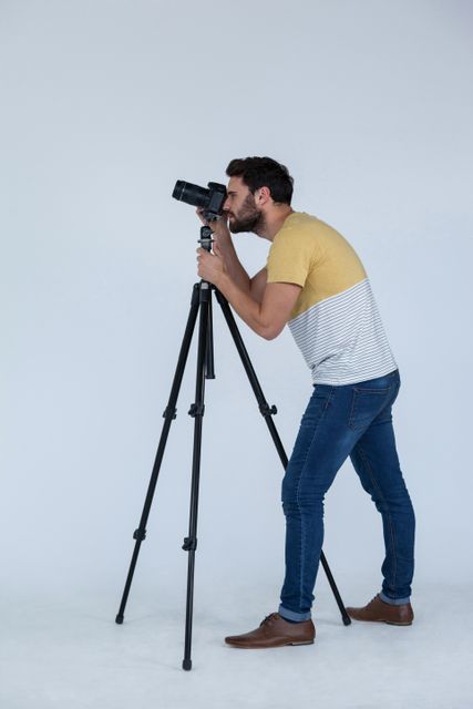 Photographer clicking picture using digital camera In the studio