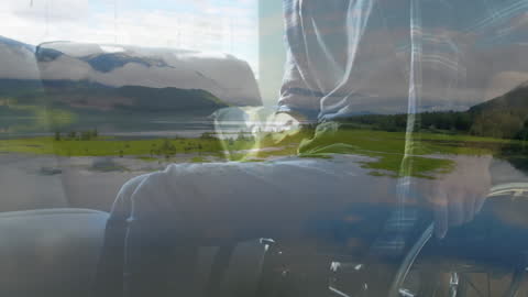 Double Exposure of Serene Landscape and Man in Wheelchair