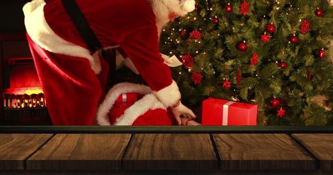 Santa Claus Delivering Gifts by Christmas Tree on Festive Night