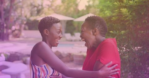 African American Sisters Hugging Cheerfully at a Resort