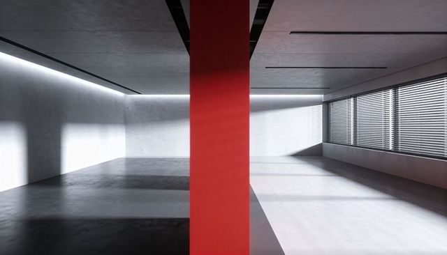 Single bright red column dividing minimal concrete interior with blinds light and shadows