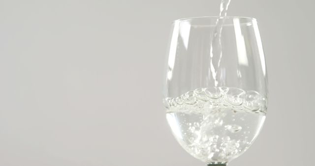 Pouring Sparkling Water into Wine Glass on White Background - Download Free Stock Images Pikwizard.com