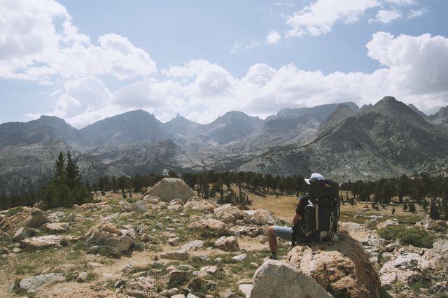 Solo Hiker Taking a Break in Rocky Mountain Landscape - Download Free Stock Photos Pikwizard.com