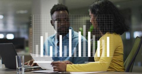 Reviewing Business Data Together in Open-Plan Office with Digital Chart Overlay
