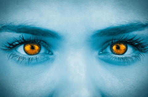 close-up of face with transparent orange eyes and blue hue - Download Free Stock Videos Pikwizard.com