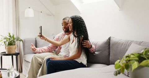Happy couple video calling and sharing engagement news