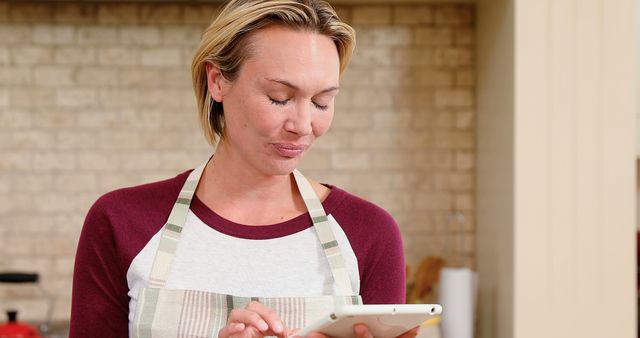 Woman Wearing Apron Using Tablet in Kitchen - Download Free Stock Images Pikwizard.com