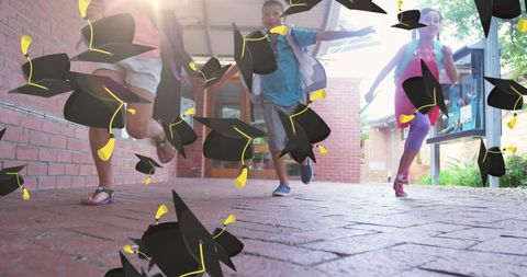 Joyful children celebrating graduation outdoors