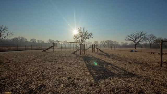 Empty playground with metal structures during sunrise