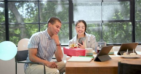 Colleagues Celebrating with Gift Sharing and Selfie in Office