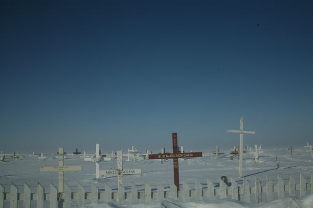 Snow-covered cemetery under clear blue sky - Download Free Stock Photos Pikwizard.com