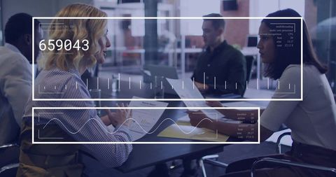 Businesswomen discussing data with HUD overlays in modern office meeting