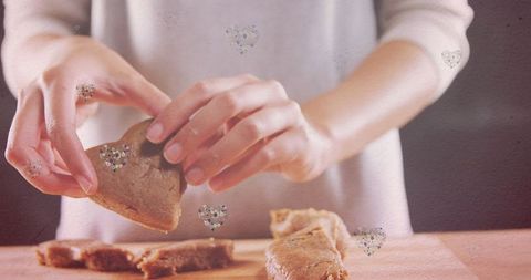 Hands Arranging Cookies with Heart Effect in Soft Focus