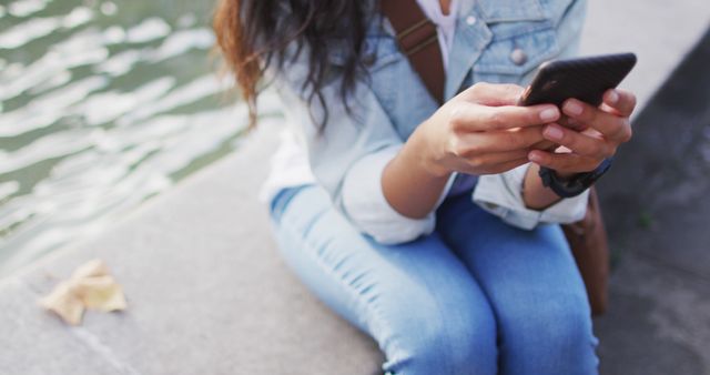 Young Woman Sitting Next to Fountain Using Smartphone - Download Free Stock Images Pikwizard.com