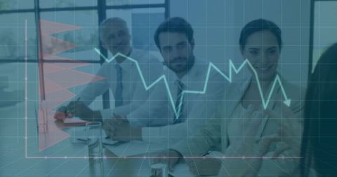 Diverse Professionals Analyzing Chart Data in Business Meeting