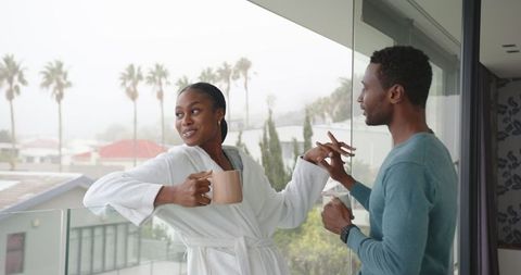Romantic Couple Relaxing with Coffee on Modern Balcony