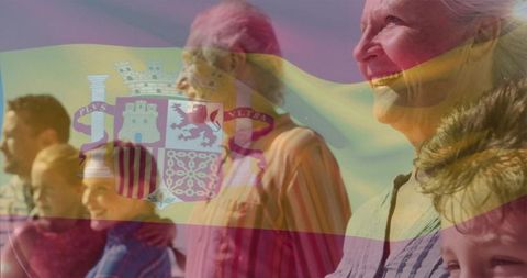 Multigenerational family posing on sunny spanish beach with translucent flag overlay