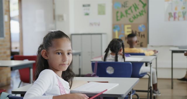 Elementary Schoolgirl Paying Attention in Classroom with Diverse Peers - Download Free Stock Images Pikwizard.com