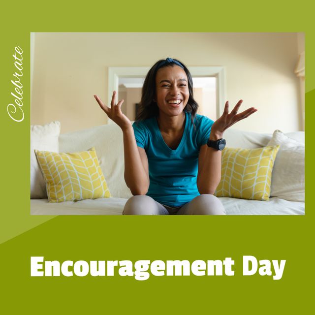 Portrait of happy biracial young woman shrugging hands on sofa and celebrate encouragement day text. Composite, copy space, inspire, togetherness, positive emotion and motivation concept.