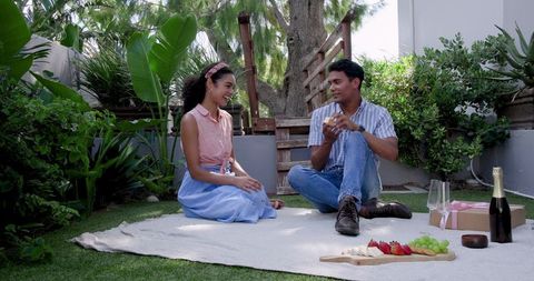 Couple Enjoying Relaxing Picnic in Scenic Garden