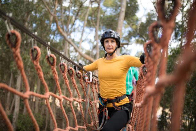 Woman Walking on Rope Bridge in Adventure Park - Download Free Stock Photos Pikwizard.com
