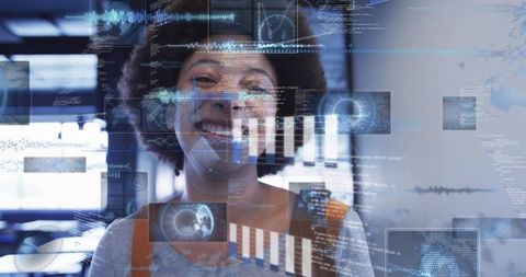 Smiling woman analyzing holographic data dashboards in high-tech workspace