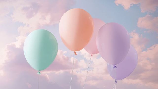 Floating pastel balloons in dreamy cloud sky, airy minimal celebration background