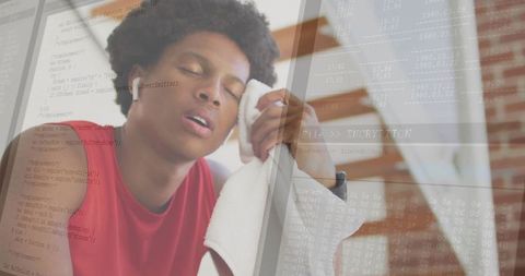 Tired Athlete Resting at Home Gym with Code Overlay