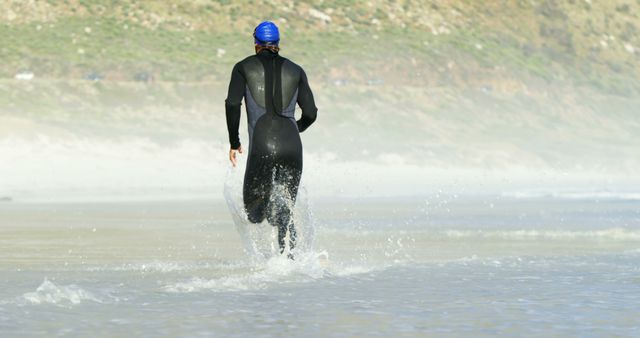 Triathlon Athlete Running Through Water on Beach - Download Free Stock Images Pikwizard.com