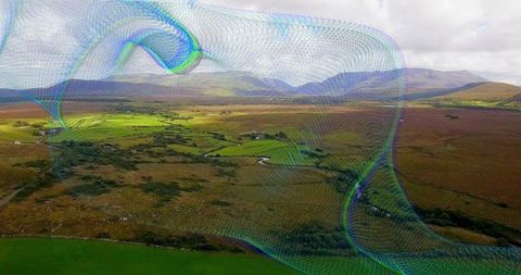 Multicolored digital mesh floating over patchwork moorland fields and meandering stream