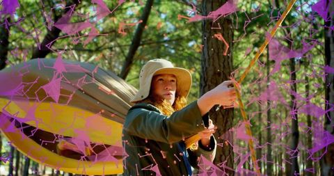 Woman Setting Up Hammock with Digital Overlay in Forest