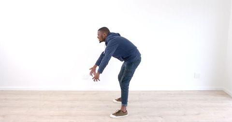 Man in Casual Clothing Practicing Dance Moves Indoors - Download Free Stock Images Pikwizard.com