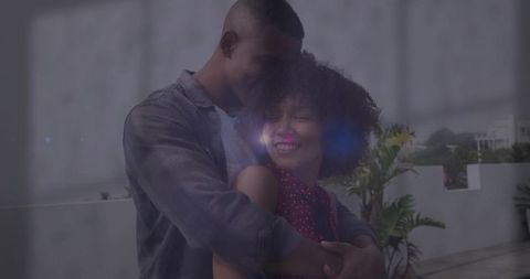 Romantic Couple Embracing on Urban Terrace with Lens Flare