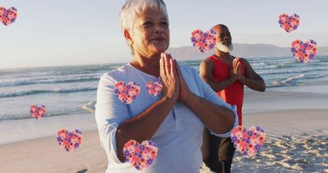 Senior Couple Practicing Yoga on Beach with Heart Icons