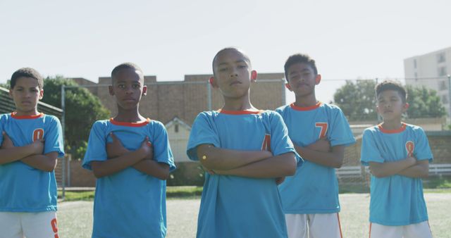 Portrait of diverse boy soccer players team in football field with copy space. Football, sports, soccer, competition, team and childhood concept, unaltered.